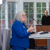 Susan Proctor smiling at podium